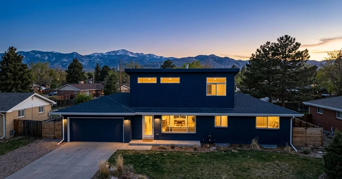 Ranch home with a new second-story pop-top against a Colorado sky